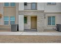 Inviting townhome entrance featuring stone accents, a porch, and desert landscaping at 6261 Dolosonte St, Las Vegas, NV 89113