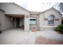Close-up of home's front entrance and porch area with desert landscaping in the front yard at 7233 Alsop Ct, Las Vegas, NV 89156