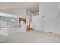 Bright living room with vaulted ceilings, neutral carpet, and staircase at 7337 Tealwood St, Las Vegas, NV 89131
