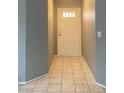 Bright entryway featuring neutral walls and tile flooring leading inside the home at 7728 Barbican Ct, Las Vegas, NV 89147