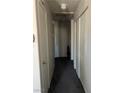 Hallway with storage closets and neutral colored carpet at 8408 W Gilmore Ave, Las Vegas, NV 89129