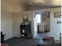 Inviting living room transitioning to a kitchen area with modern appliances and ample storage at 8408 W Gilmore Ave, Las Vegas, NV 89129