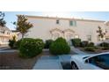 Exterior of condo showing front door entrances, sidewalks and green bushes at 8628 Tomnitz Ave # 101, Las Vegas, NV 89178