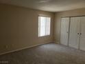 Neutral bedroom with carpet, natural light from window, and closet with double doors at 9325 W Desert Inn Rd # 233, Las Vegas, NV 89117