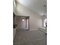Bright living room featuring high ceilings, new carpet, and a window seat under a large window at 9325 W Desert Inn Rd # 233, Las Vegas, NV 89117