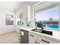 Bright kitchen with stainless steel appliances and a window overlooking the pool at 9795 La Cienega St, Las Vegas, NV 89183