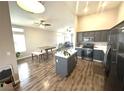 Open-concept kitchen with gray cabinets, stainless appliances, and an island at 981 Leadville Meadows Dr, Henderson, NV 89052