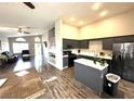 Open-concept living space with kitchen featuring gray cabinetry, an island, and stainless steel appliances at 981 Leadville Meadows Dr, Henderson, NV 89052