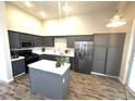 Updated kitchen features gray cabinets, stainless steel appliances, and a center island at 981 Leadville Meadows Dr, Henderson, NV 89052