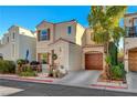 Charming two-story home featuring a front porch, a red tile roof, and an attached garage at 10374 Midnight Iris St, Las Vegas, NV 89183