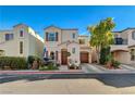 Charming two-story home featuring a front porch, a red tile roof, and an attached garage at 10374 Midnight Iris St, Las Vegas, NV 89183