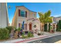 Charming two-story home featuring a front porch, a red tile roof, and an attached garage at 10374 Midnight Iris St, Las Vegas, NV 89183