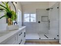 This bathroom showcases a stylish vanity and walk-in shower with modern fixtures and bright natural light at 10976 Salernes St, Las Vegas, NV 89141