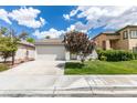 Charming single-story home with a well-maintained lawn, a tree, and an attached two-car garage at 10976 Salernes St, Las Vegas, NV 89141