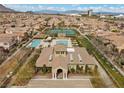 Aerial view of community pool and tennis courts, lush landscaping, and well-maintained amenities at 11322 Corsica Mist Ave, Las Vegas, NV 89135