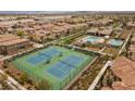 Aerial view of tennis courts and community pool, set amongst beautiful homes in Traccia at 11322 Corsica Mist Ave, Las Vegas, NV 89135