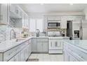 Modern kitchen featuring stainless steel appliances, quartz countertops and tiled backsplash at 1312 Frost Flower Dr, North Las Vegas, NV 89032