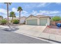 Lovely single-story home with palm trees and a spacious three-car driveway at 2151 Babylon Mill St, Henderson, NV 89002