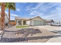 Attractive single-story home featuring desert landscaping and a three-car garage at 2151 Babylon Mill St, Henderson, NV 89002