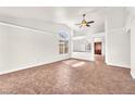 Bright and airy living room with tile flooring and a modern ceiling fan at 2151 Babylon Mill St, Henderson, NV 89002