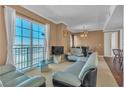 Bright living room offering a large window with city views, modern furniture, and tan walls at 2405 W Serene Ave # 817, Las Vegas, NV 89123