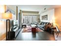 Open living room with modern furniture, hardwood floors and glass doors leading to a balcony at 2700 Las Vegas Blvd # 910, Las Vegas, NV 89109