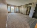 Spacious living room with a sliding glass door and neutral carpet flooring at 2867 Geary Pl # 3008, Las Vegas, NV 89109