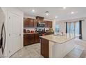 Bright kitchen boasts tile floors, granite counters, and dark wood cabinets at 2945 Torreon Ln, Las Vegas, NV 89121