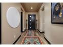 Modern foyer featuring stylish decor, hardwood floors, and contemporary lighting fixtures at 33 Desert Juniper Ln, Henderson, NV 89011