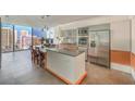 Modern kitchen featuring stainless steel appliances, island, and expansive windows offering stunning city views at 3722 Las Vegas Blvd # 1204, Las Vegas, NV 89158