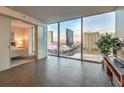 Bright living room with large windows offering panoramic city views, seamlessly connected to an adjacent bedroom at 3722 Las Vegas Blvd # 1204, Las Vegas, NV 89158