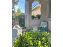 Charming front porch with decorative plants and a cozy seating area creating a welcoming entrance at 4534 Regalo Bello St, Las Vegas, NV 89135