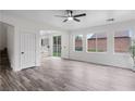 Bright and airy living room with wood-look tile floors and plenty of natural light from large windows at 4905 Madre Maria Ct, North Las Vegas, NV 89031