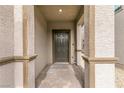 Covered front porch with stone pillars and a dark front door at 6130 Sinks Canyon Ave, Las Vegas, NV 89130