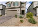 Charming two-story home with a two car garage and desert landscaping with a brick paver driveway at 6130 Sinks Canyon Ave, Las Vegas, NV 89130