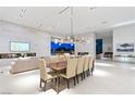 Spacious dining area featuring modern light fixtures and seamless access to outdoor entertainment space at 63 Midnight Sky Dr, Las Vegas, NV 89135