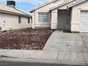 Well-maintained front yard with minimal landscaping and a concrete walkway leading to the front door at 6608 Elk Creek Ln, Las Vegas, NV 89156