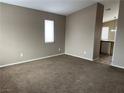 Cozy living room with neutral walls and plush carpeting, creating a warm and inviting atmosphere at 6608 Elk Creek Ln, Las Vegas, NV 89156