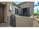 A stylish courtyard at the front entrance with wrought iron gate and stone pavers at 6630 Windy Palm St, North Las Vegas, NV 89086