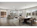 Open-concept living and dining area with fireplace, neutral tones and ample natural light at 6630 Windy Palm St, North Las Vegas, NV 89086