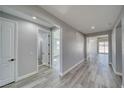 Bright hallway features wood-look floors, neutral walls, and access to various rooms at 6631 S Parkwood Ct, Pahrump, NV 89061
