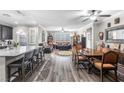 Open-concept layout featuring a kitchen island, dining area, and comfortable seating area with lots of light at 7148 Stanley Frederick St, Las Vegas, NV 89166