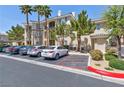 Condominium building exterior featuring well-maintained landscaping and convenient parking spaces in front at 7155 S Durango Dr # 303, Las Vegas, NV 89113