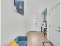 Bright foyer with wood floors, high ceilings and modern decor with a teal accent wall at 752 Echelon St, Las Vegas, NV 89138