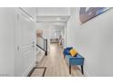 Bright foyer with wood floors, stairwell with iron handrails and decoratively appointed bench seating at 752 Echelon St, Las Vegas, NV 89138