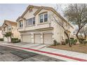 Two-story stucco townhouse with three garages and a desert landscaped yard at 8787 Roping Rodeo Ave # 101, Las Vegas, NV 89178
