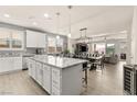 Open-concept kitchen with a large island, granite countertops, stainless steel appliances, and plenty of cabinet space at 896 Janefield St, Las Vegas, NV 89148