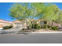 Inviting home showcases desert landscaping, a mature shade tree, and an attached two-car garage at 9108 Tuxpan St, Las Vegas, NV 89131