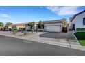 Well-maintained single-story home with a three-car garage and tidy desert landscaping at 9485 Parkmoor Ave, Las Vegas, NV 89149