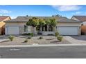 Inviting single-story home with a three-car garage and desert landscaping at 9485 Parkmoor Ave, Las Vegas, NV 89149